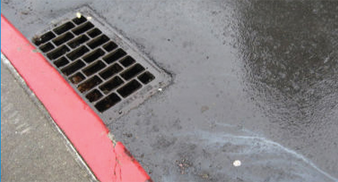 A new storm drain installed near a marked curb.
